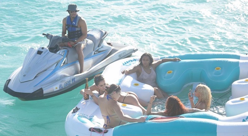 T.I. with women beside yacht