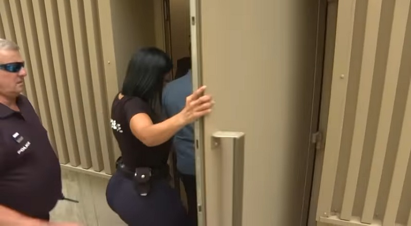 Female officer's bottom steals attention from arrest