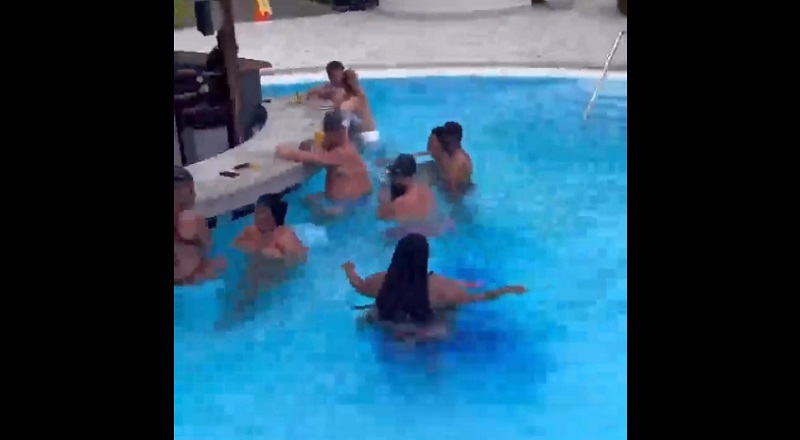 Woman uses the bathroom on herself in crowded pool