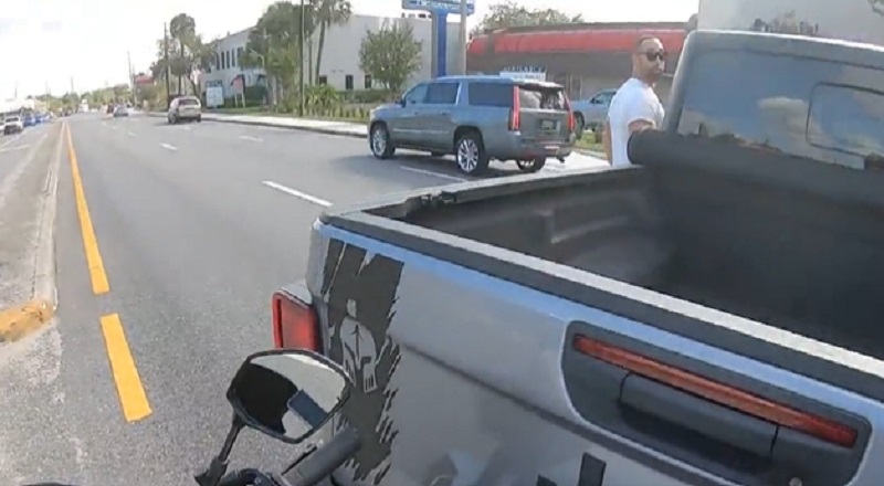 Motorcycle rider confronts driver who cut him off